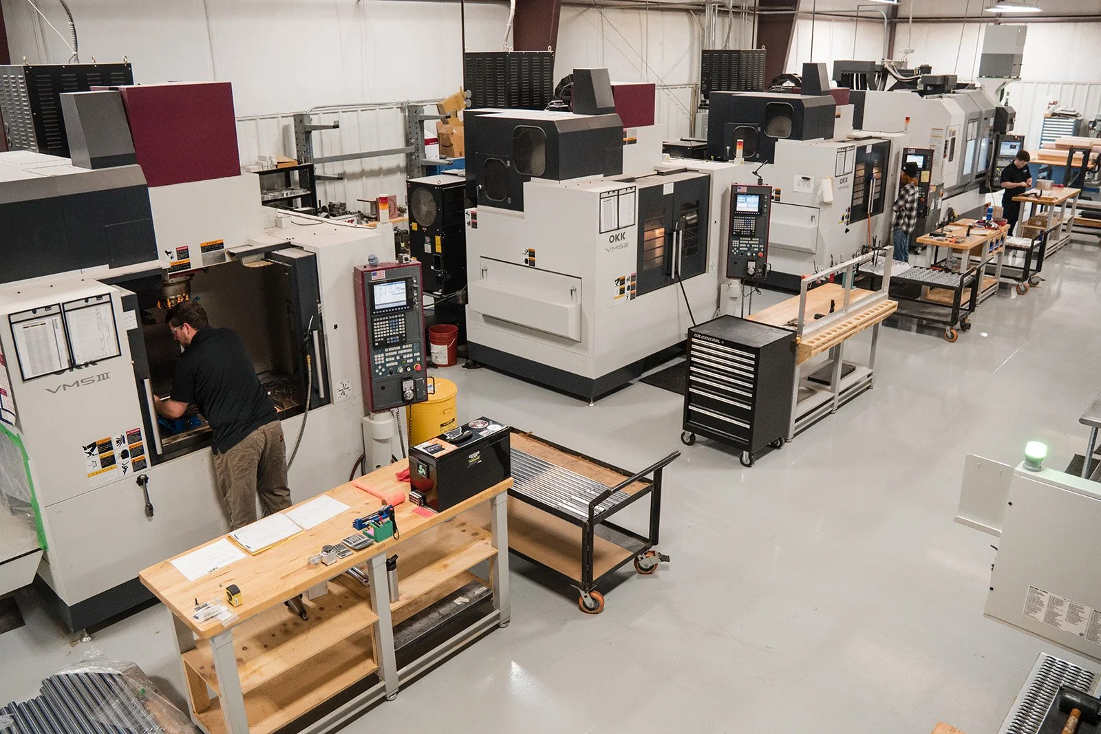 A precision engineering machine shop floor with several CNC machines